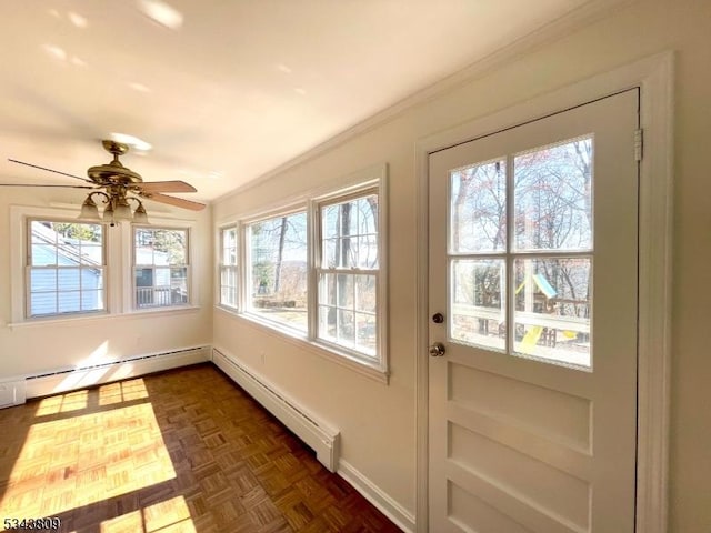 unfurnished sunroom featuring baseboard heating, ceiling fan, and a baseboard radiator