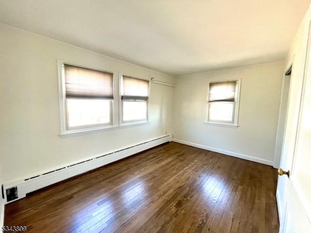 unfurnished bedroom featuring dark wood-style flooring, multiple windows, baseboards, and a baseboard radiator