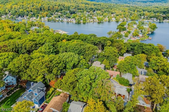 aerial view with a forest view and a water view