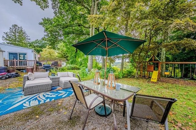 view of patio / terrace with a wooden deck, an outdoor hangout area, outdoor dining space, and a playground