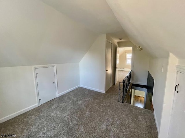 bonus room featuring carpet flooring, lofted ceiling, and baseboards