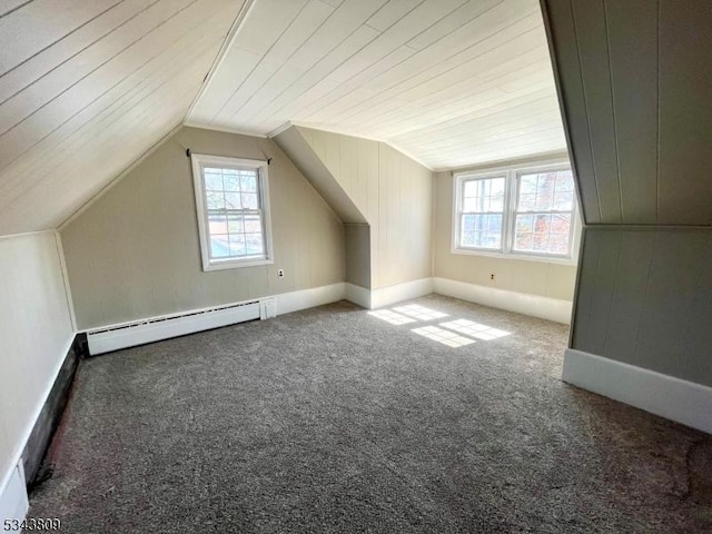 bonus room featuring a baseboard heating unit, lofted ceiling, and carpet