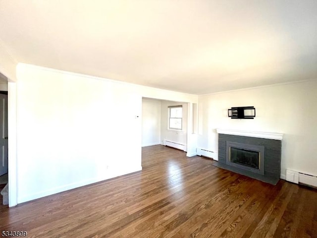 unfurnished living room with dark wood finished floors, a fireplace with flush hearth, ornamental molding, baseboard heating, and a baseboard radiator