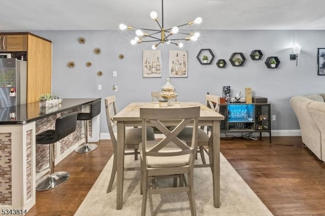 dining room with an inviting chandelier, wood finished floors, and baseboards