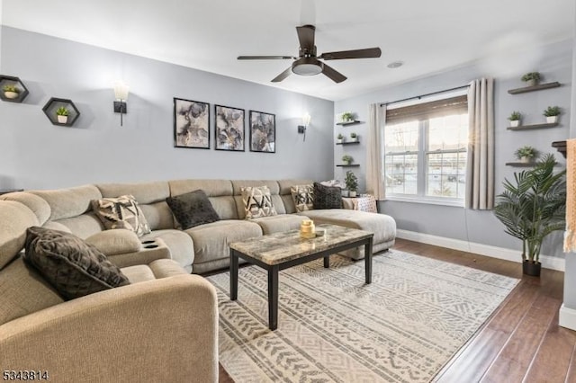 living area with ceiling fan, baseboards, and dark wood finished floors