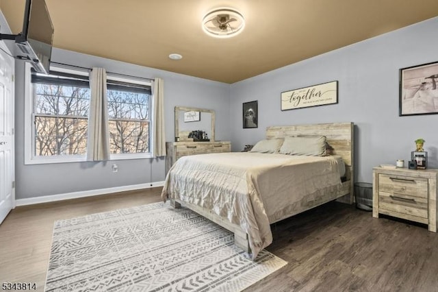 bedroom featuring baseboards and wood finished floors