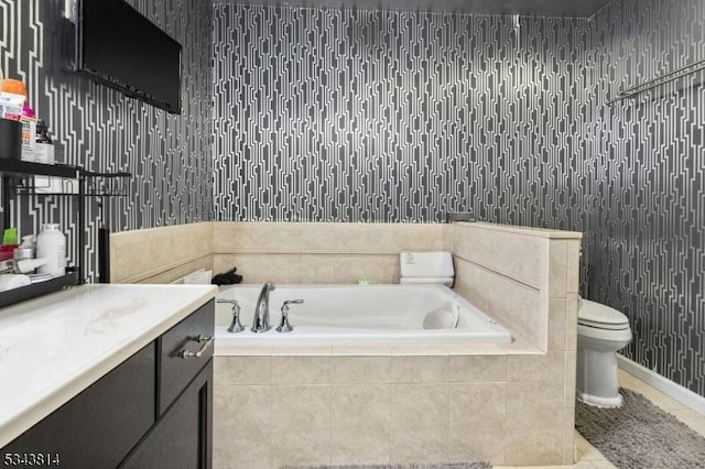 bathroom featuring a bath, tile patterned floors, toilet, and vanity