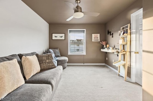 living area with baseboards, carpet floors, and ceiling fan