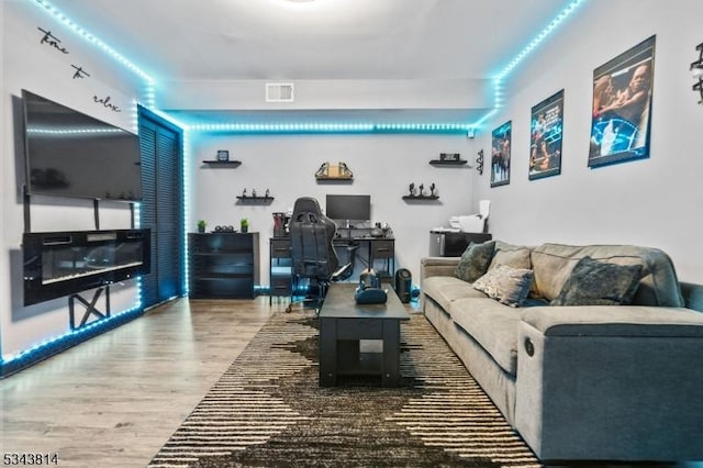 living room with visible vents and wood finished floors