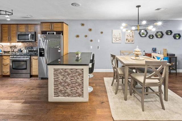 dining area with a notable chandelier, baseboards, dark wood-type flooring, and visible vents