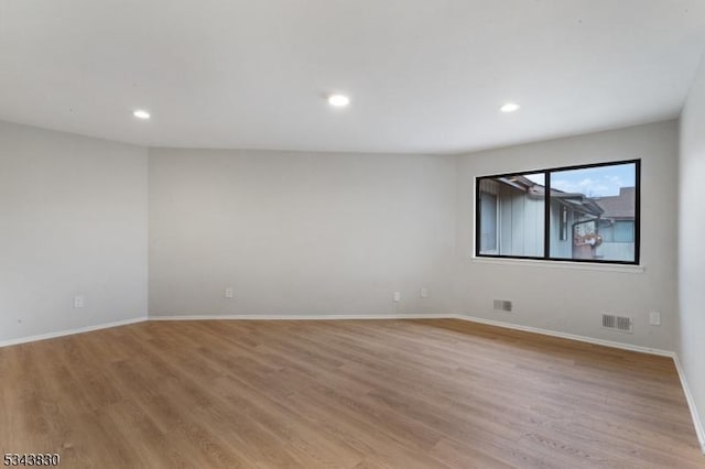 unfurnished room featuring recessed lighting, visible vents, light wood finished floors, and baseboards