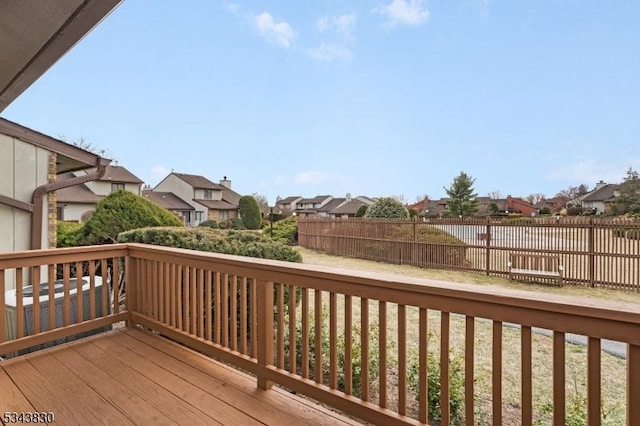 wooden terrace with a residential view and fence