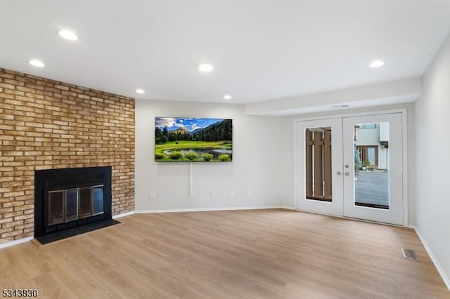 unfurnished living room featuring light wood finished floors, visible vents, french doors, and baseboards