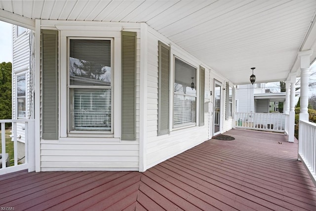 wooden terrace featuring covered porch