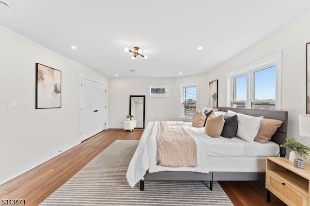 bedroom featuring recessed lighting, baseboards, and wood finished floors