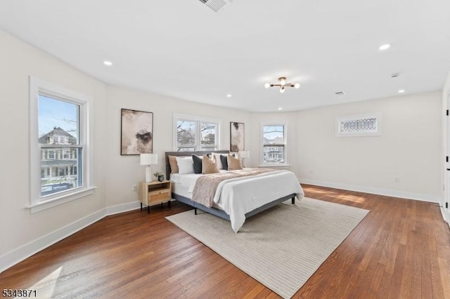 bedroom featuring visible vents, recessed lighting, wood finished floors, and baseboards