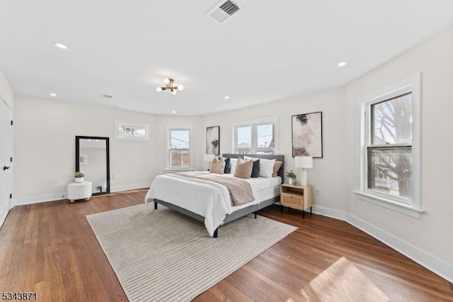 bedroom featuring visible vents, recessed lighting, baseboards, and wood finished floors