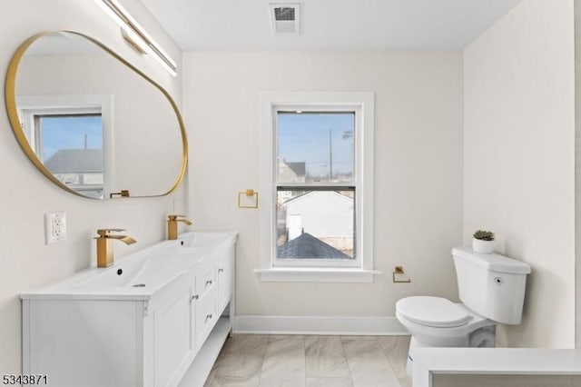 full bath featuring visible vents, marble finish floor, toilet, and a sink