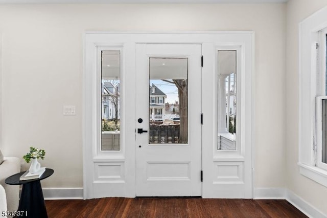 entryway featuring baseboards and dark wood finished floors