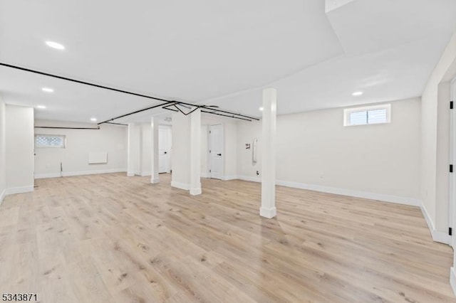 basement featuring recessed lighting, baseboards, and light wood-type flooring