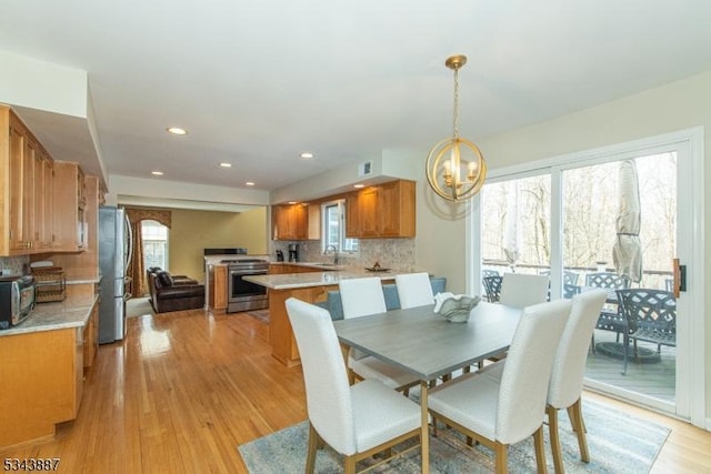 dining room with recessed lighting, visible vents, light wood-style floors, and a chandelier