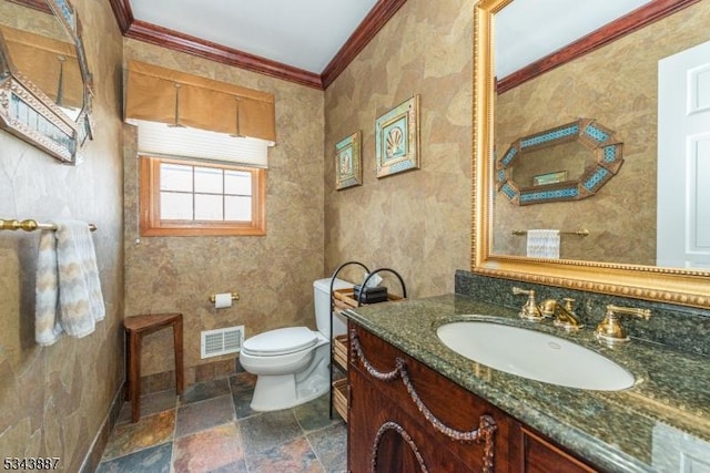 bathroom with visible vents, toilet, stone tile floors, crown molding, and baseboards