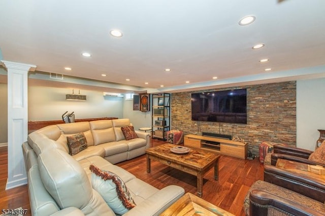 living room with recessed lighting, wood finished floors, visible vents, and ornate columns