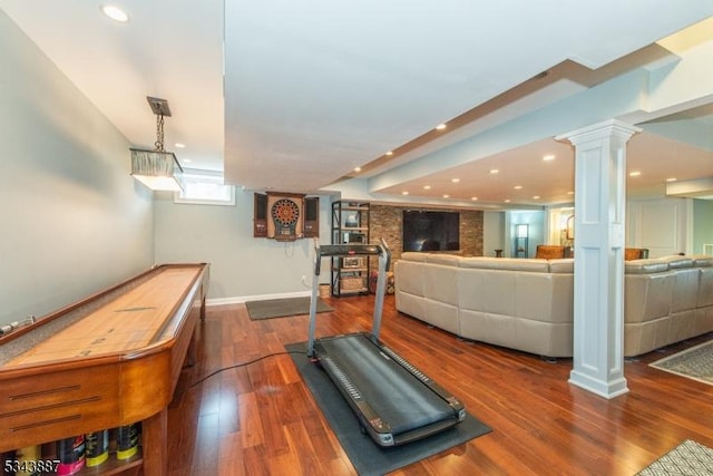 workout area featuring recessed lighting, baseboards, ornate columns, and wood finished floors