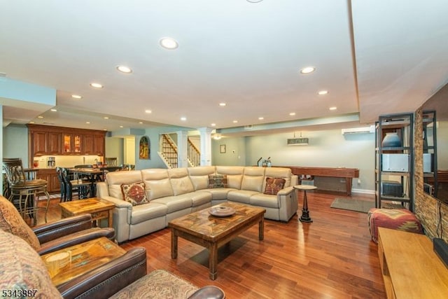 living room with recessed lighting, stairs, ornate columns, and wood finished floors