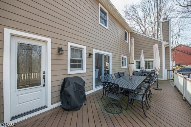 deck with outdoor dining space and area for grilling