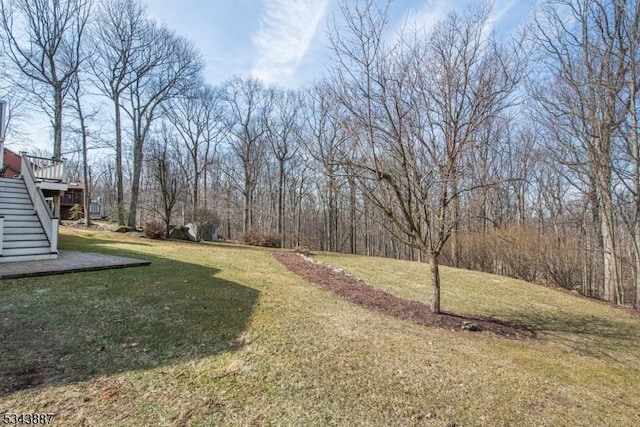 view of yard with a deck and stairway