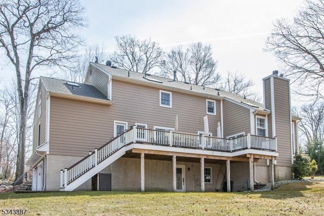 rear view of property with stairs, a yard, a wooden deck, and a chimney