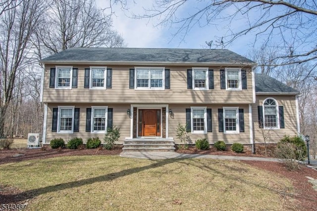 colonial inspired home with a front yard