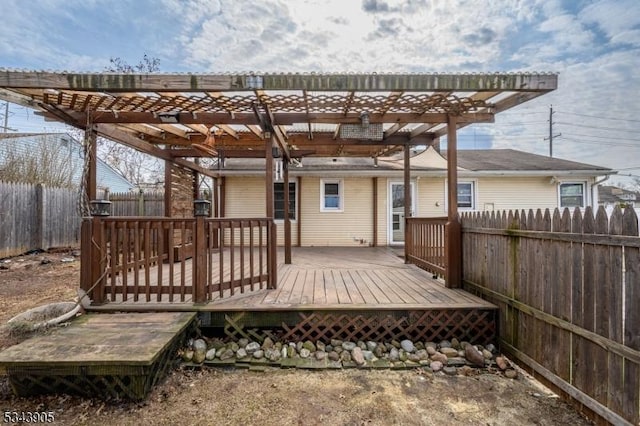 deck featuring fence and a pergola