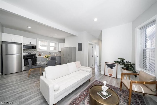 living room featuring plenty of natural light, recessed lighting, and light wood-style floors