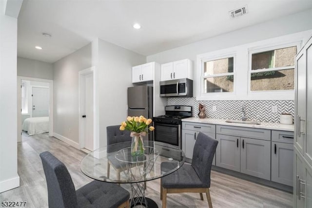 dining space featuring recessed lighting, visible vents, light wood-style flooring, and baseboards