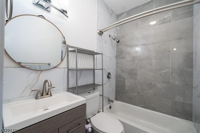 bathroom with washtub / shower combination, tasteful backsplash, vanity, and toilet