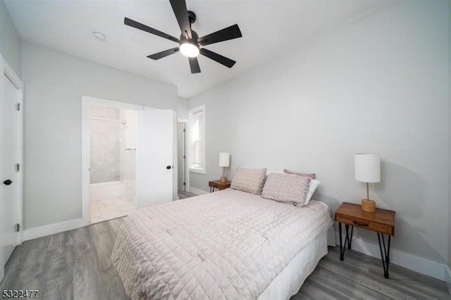 bedroom featuring a ceiling fan, wood finished floors, baseboards, and connected bathroom