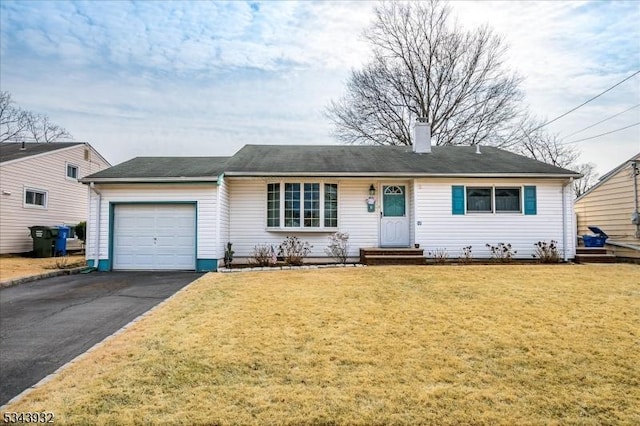 ranch-style home featuring entry steps, driveway, a front lawn, and a garage