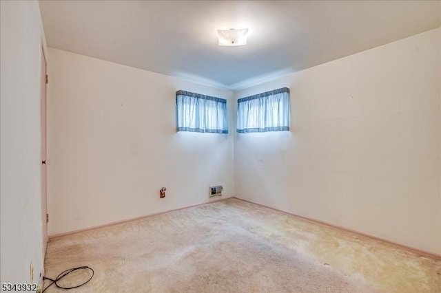 spare room featuring visible vents and carpet floors