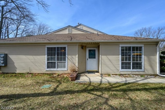 rear view of property with a lawn