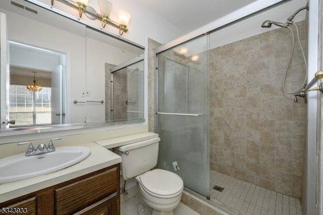 full bathroom with visible vents, a notable chandelier, toilet, a shower stall, and vanity