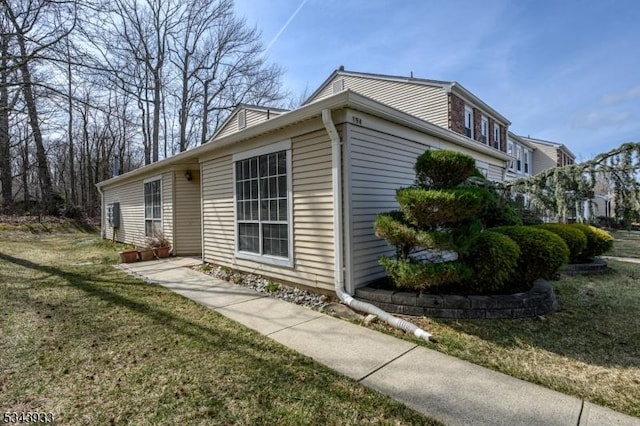 view of home's exterior with a yard