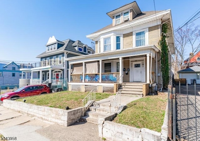 american foursquare style home with covered porch and a front lawn