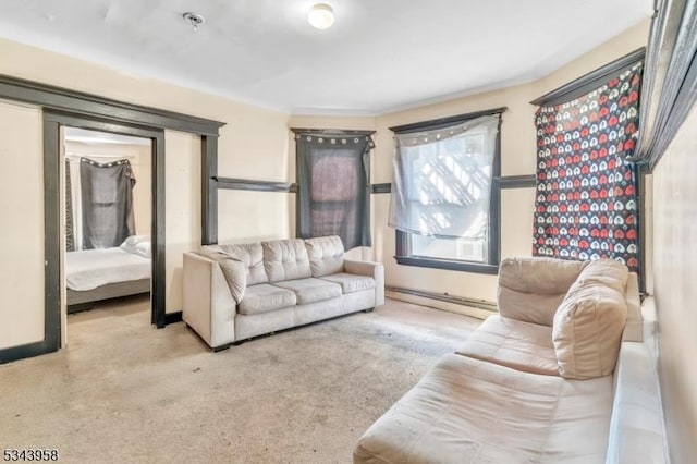 carpeted living area featuring baseboards and baseboard heating