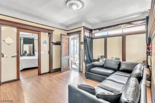 living room with light wood-type flooring and baseboards