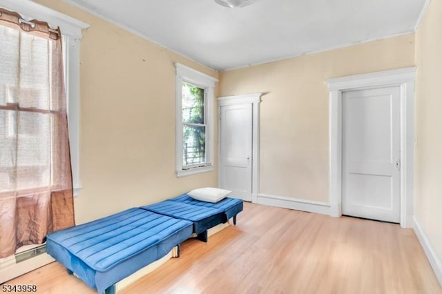 bedroom with wood finished floors and baseboards