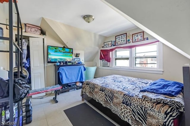 tiled bedroom featuring lofted ceiling