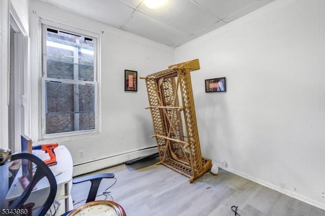 living area featuring baseboards and wood finished floors