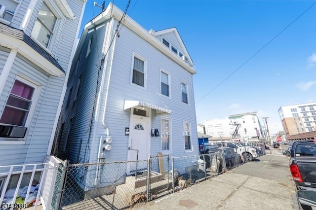 view of front of property featuring fence